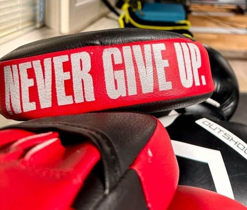 "Never give up" yazılı boks eldivenleri